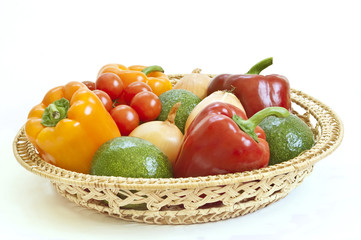 Fresh vegetables in a basket on white background
