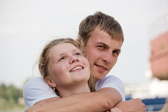 The guy embraces the girl