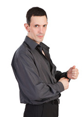 Young man buttoning-up a sleeve of his black shirt