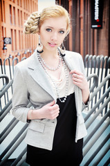 Portrait of the beautiful young woman in the modern city