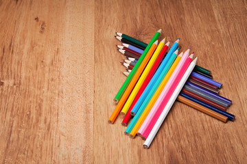 Assortment of colored pencils on wooden table