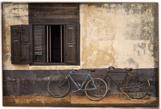 2 old bicycles and a window