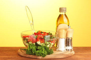 Fresh salad and oil on green background