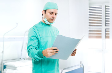 Surgeon reading a case history