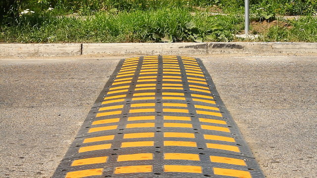 Speed bump on a road when a car is passing