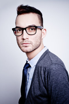 closeup portrait of handsome young adult man wearing glasses
