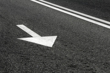 Road marking on asphalt in the form of an arrow