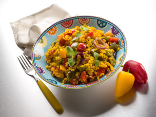 risotto with saffron and capsicum over steel background