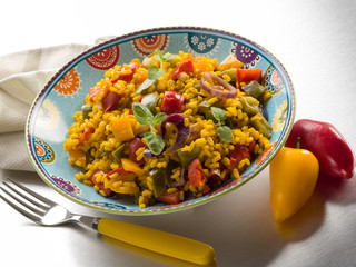 risotto with saffron and capsicum over steel background