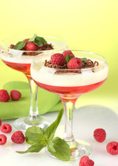 fruit jelly with berries in glasses on green background