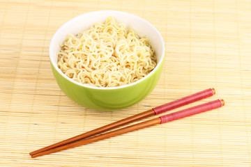 asian noodles in bowl on bamboo mat