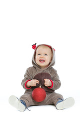 Smiling baby with Christmas ball looking up on copy space © Alliance