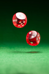 Rolling red dice on a casino table