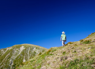 Boy hiking into the mountains