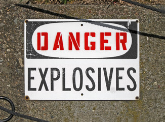 danger explosives, warning message on signboard on stone wall, restricted area, ammunition depot, hazard environment, military security diversity