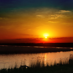 Fototapeta na wymiar red sunset over river