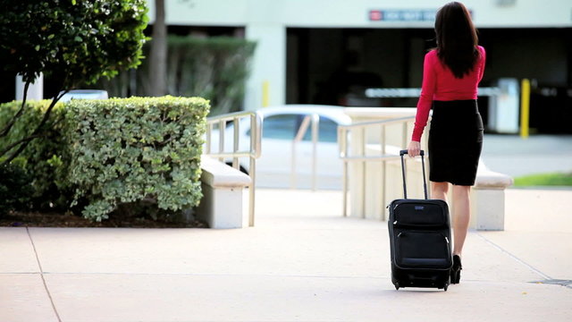 Businesswoman on Smart Phone with Travel Luggage