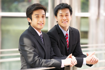 Two Chinese Businessmen Outside Modern Office