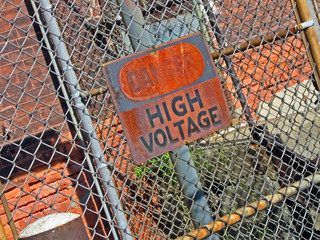 danger - high voltage, warning message on vintage signboard, power outage diversity
