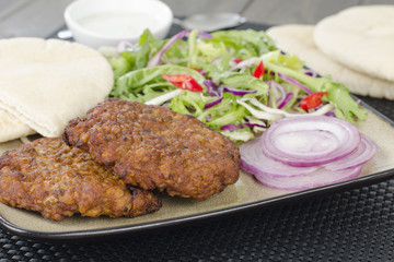 Shami Kebab - Spicy lamb patties with mint raita, salad & pitta