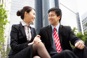 Fototapeta premium Chinese Businessman And Businesswoman Talking Outside Office
