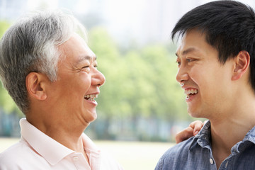 Portrait Of Chinese Father With Adult Son In Park