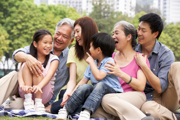 Portrait Of Multi-Generation Chinese Family Relaxing In Park