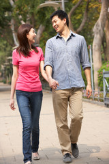 Fototapeta premium Young Chinese Couple Walking In Park