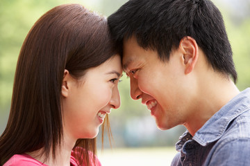 Portrait Of Young Chinese Couple Looking At Each Other
