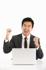 Chinese Businessman Working On Laptop And Celebrating