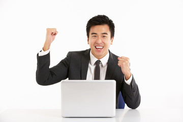 Chinese Businessman Working On Laptop And Celebrating