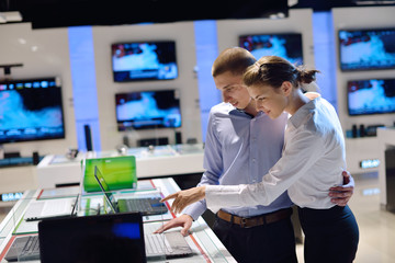 Young couple in consumer electronics store