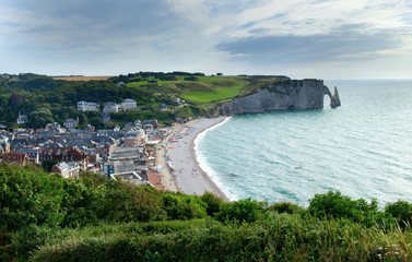 Scenic view of Etretat town with its beach and famous cliffs wit