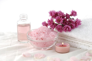 Obraz na płótnie Canvas towel and plum flower. candle, salt in bowl, massage oil