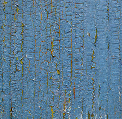 Cracked paint on a wooden surface. Grunge style background.