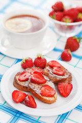 French toasts with powdered sugar and a strawberry