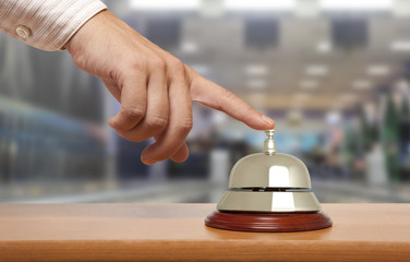Hand of a man using a hotel bell