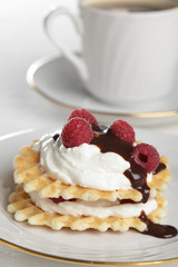 Breakfast with waffles, yogurt, raspberry, and chocolate