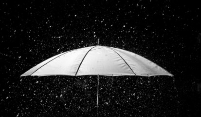 Umbrella under raindrops in black and white