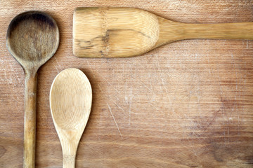 Old grunge wooden cutting kitchen desk board with spoon