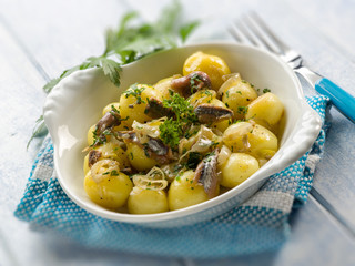 potatoes salad with anchovies onions and parsley, selective focu