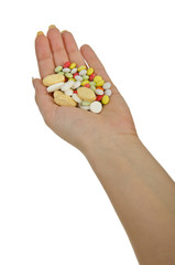 Hands holding pills on white