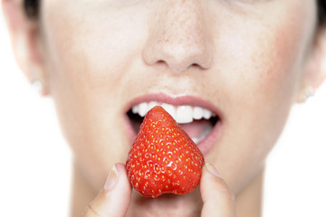 Woman eating fresh strawberry