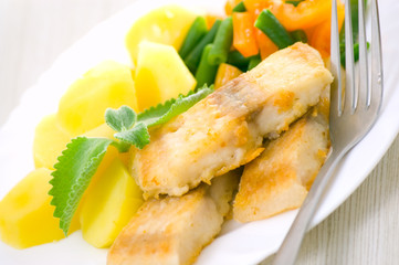 fried fish with vegetables and potato for dinner