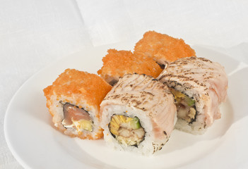 Two types of rolls on white plate with linen background