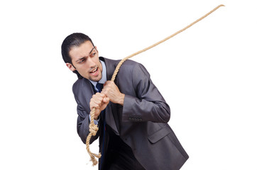 Businessman pulling rope on white