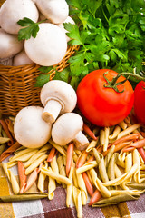 Wicker basket full of fresh champignon mushrooms