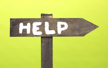 Help wooden board on green background