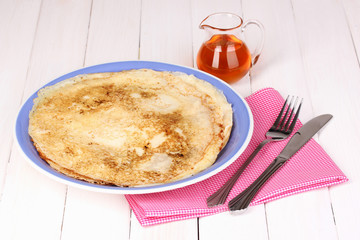 Stack of tasty pancakes on wooden background