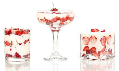 Glasses of ripe strawberries with cream isolated on white